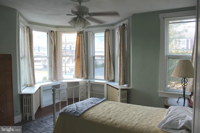 a view of a hallway with wooden floor and windows