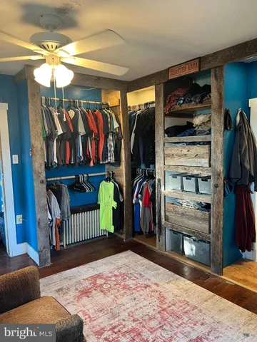 a living room with furniture and a ceiling fan