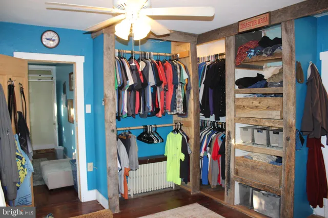 a view of a bedroom with a bed and a window