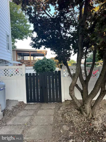 a front view of a house with a tree