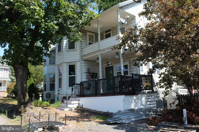 a kitchen with stainless steel appliances kitchen island granite countertop a refrigerator and a sink