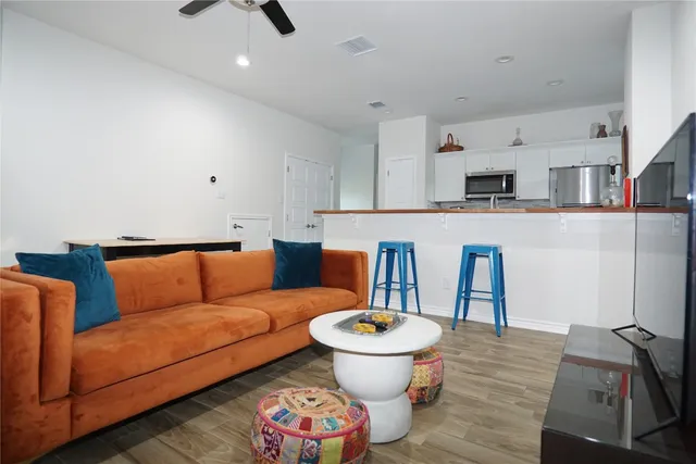 a living room with furniture a rug and white walls