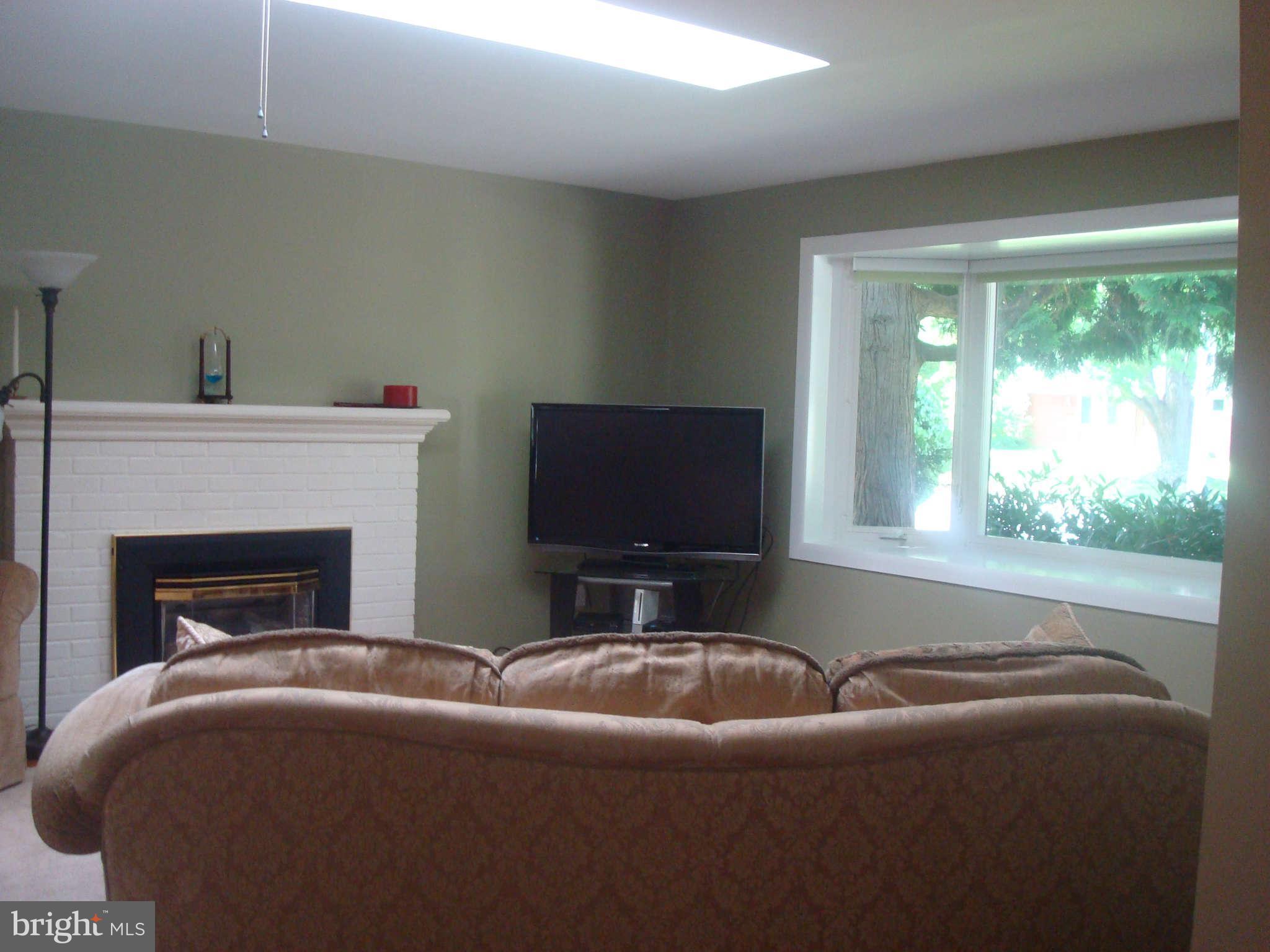 7413 Farnum Street Springfield, VA 22151 - Photo 2 of 17 a living room with furniture and a fireplace