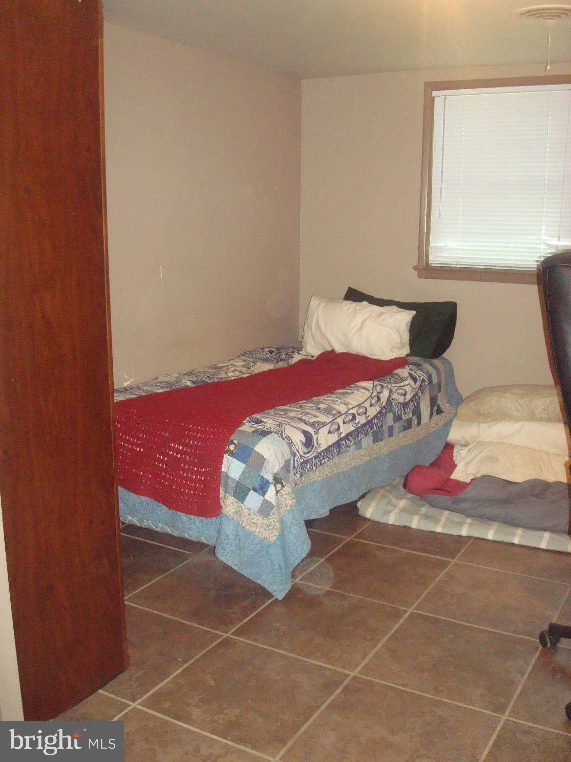 7413 Farnum Street Springfield, VA 22151 - Photo 11 of 17 a bed sitting in a bedroom next to a window