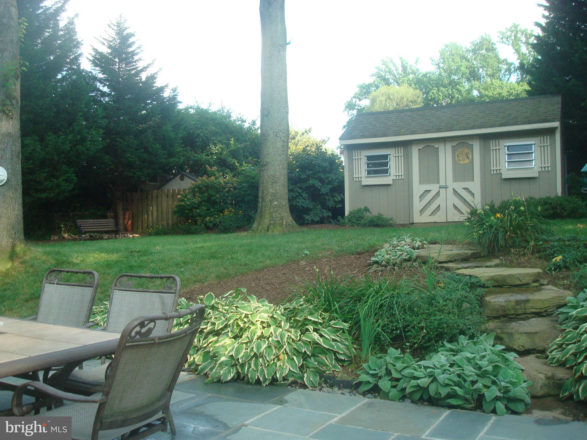7413 Farnum Street Springfield, VA 22151 - Photo 15 of 17 a view of a house with backyard sitting area and garden