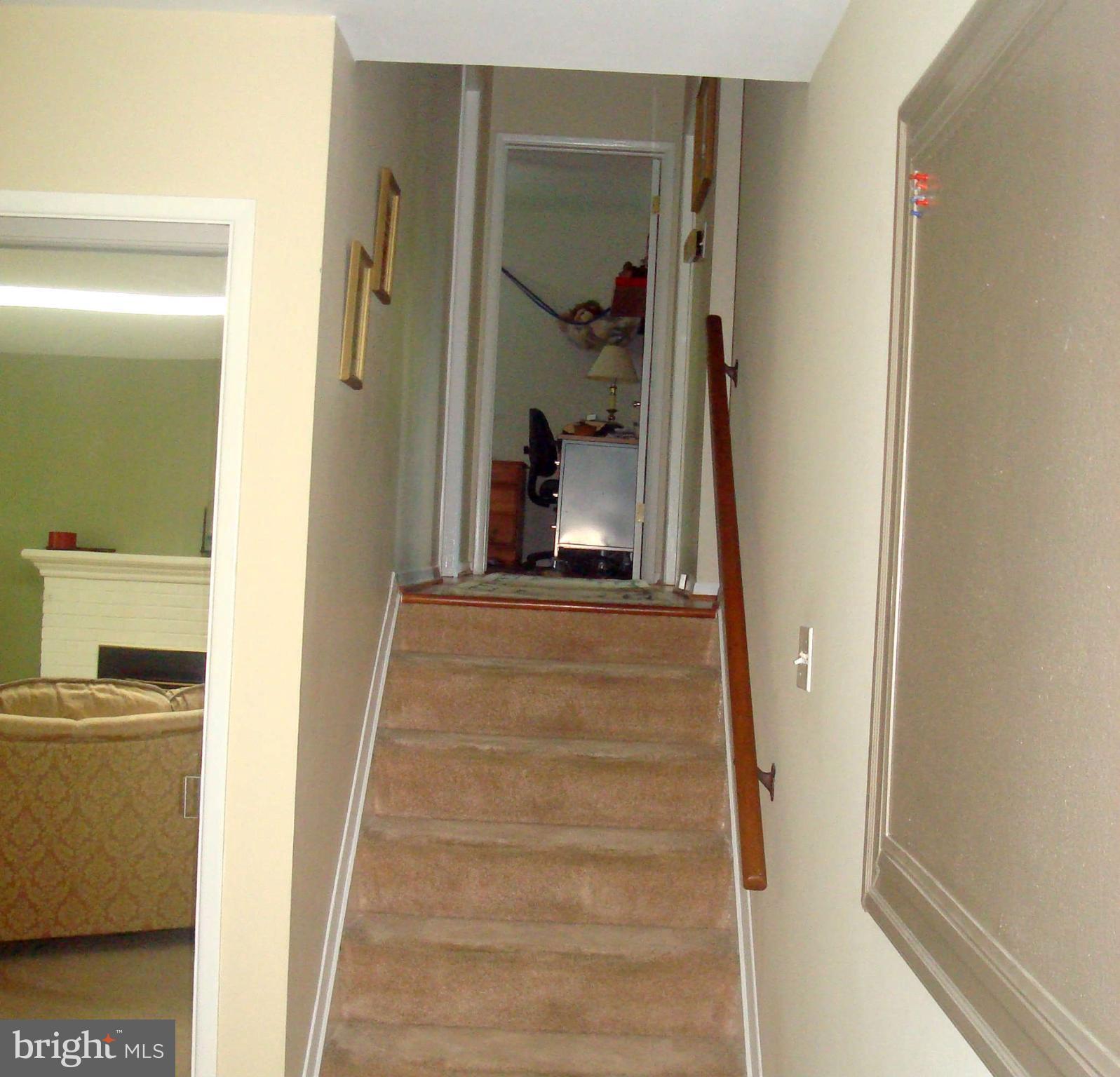 7413 Farnum Street Springfield, VA 22151 - Photo 5 of 17 a view of a hallway with wooden floor and staircase