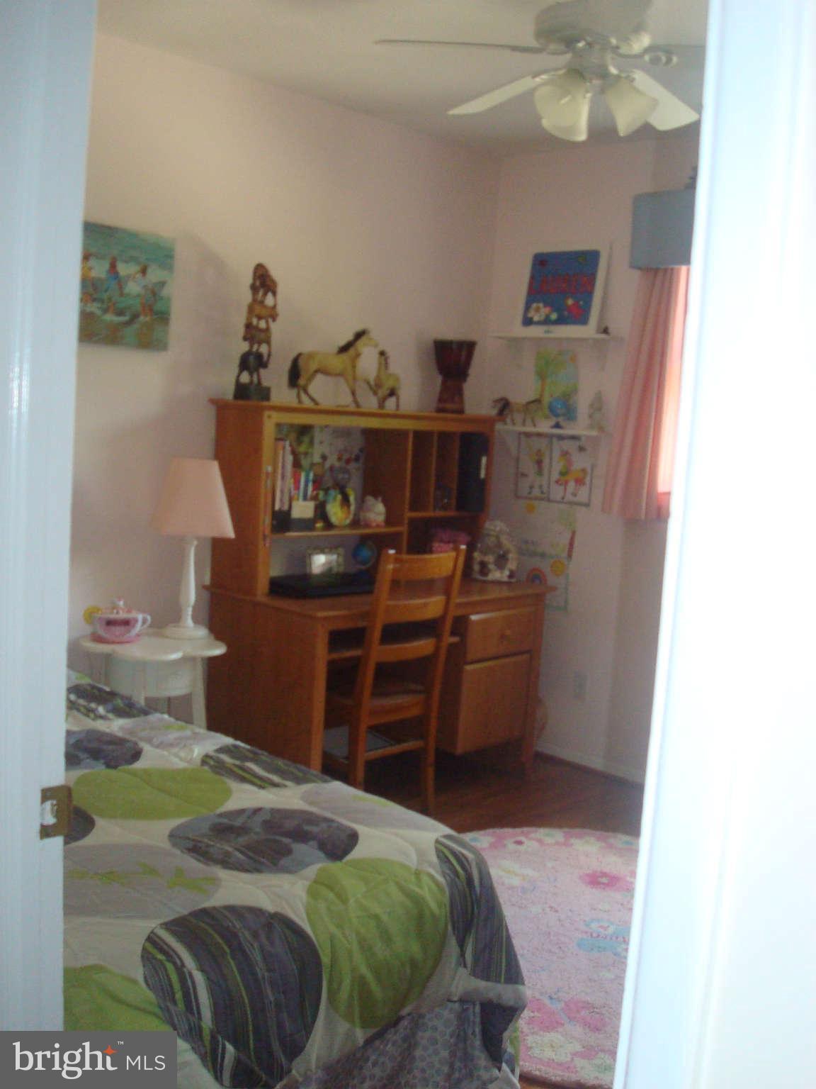 7413 Farnum Street Springfield, VA 22151 - Photo 7 of 17 a bed room with a bed and a television