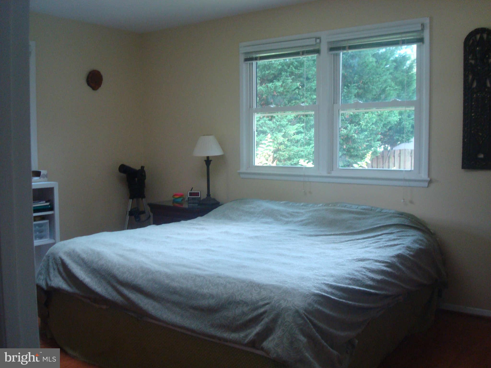 7413 Farnum Street Springfield, VA 22151 - Photo 10 of 17 a bed sitting in a bedroom next to a window