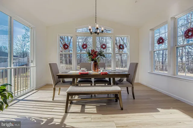 a view of a dining room with furniture wooden floor and a chandelier