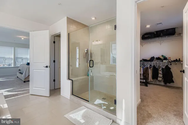 a bedroom with a bed next to a window