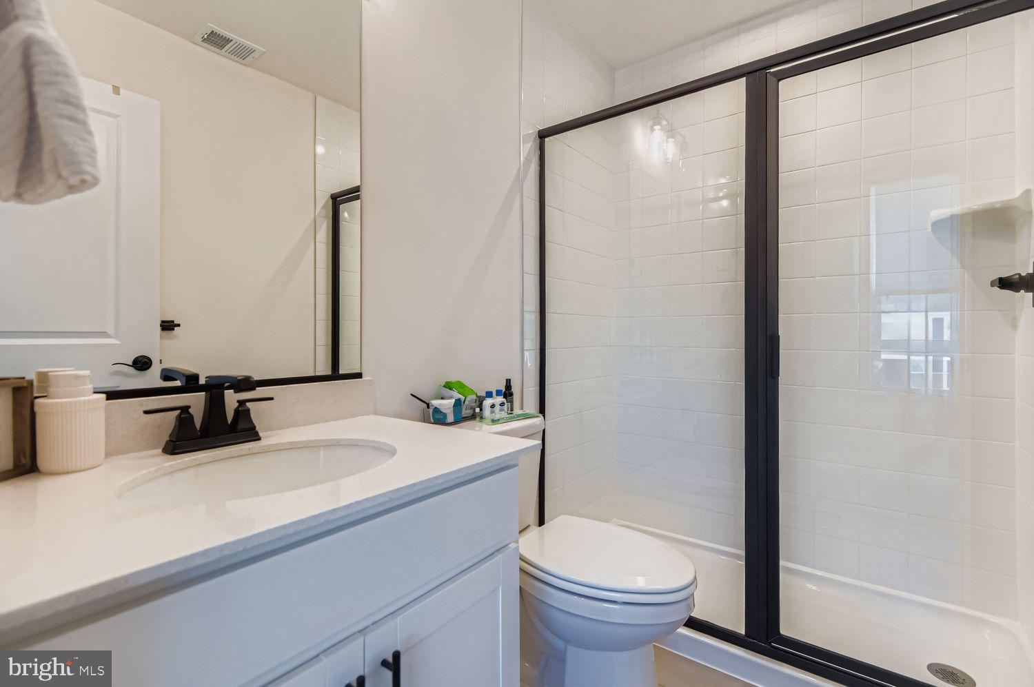 5708 Charlies Way White Marsh, MD 21162 - Photo 23 of 39 a bathroom with a granite countertop sink toilet and shower