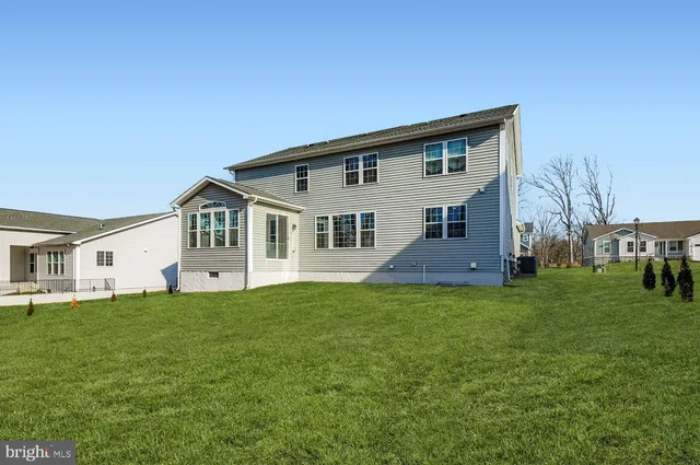 a front view of house with yard and green space