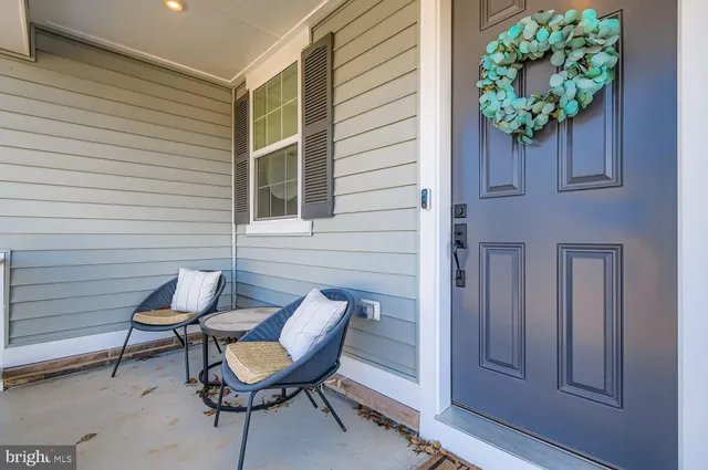 a porch with a table and chairs