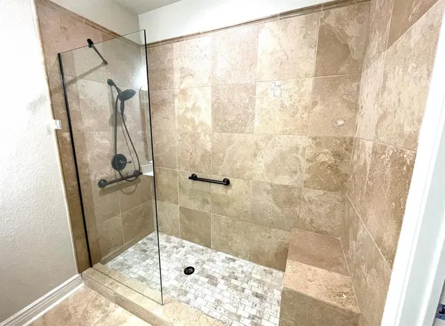 a bathroom with a glass shower door