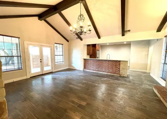 a view of an entryway with wooden floor