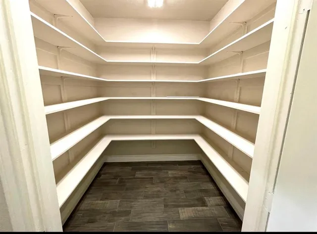 a view of walk in closet with empty racks