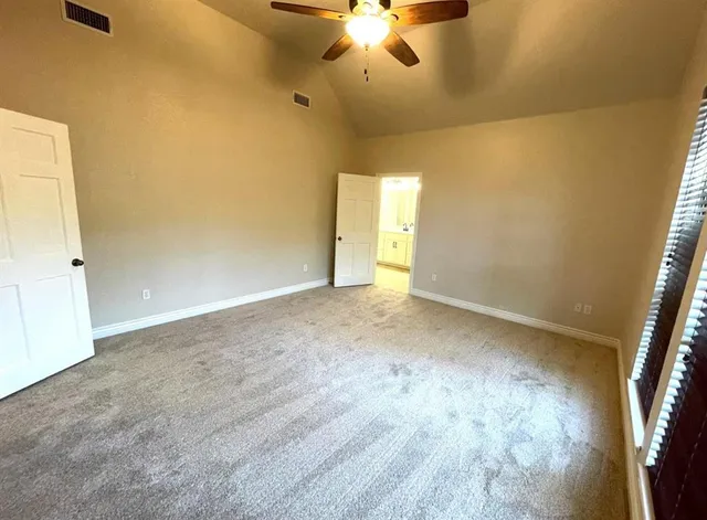 an empty room with a empty space and a ceiling fan