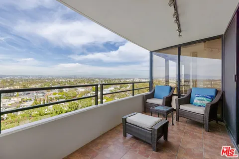 a balcony with furniture and city view