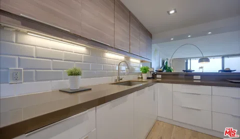 a kitchen with sink and cabinets