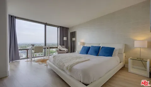 a large bedroom with a large bed and a large window