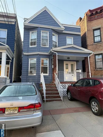 a front view of a house with parking space
