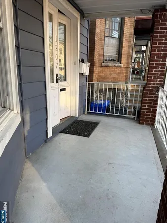 a backyard view of a house with basket ball court