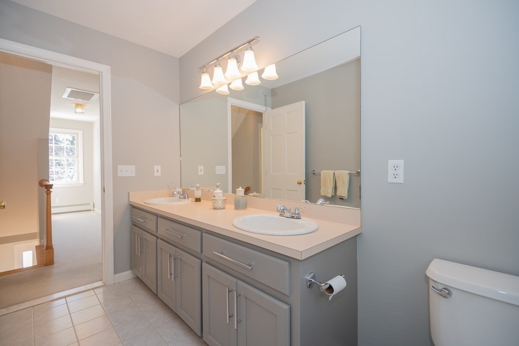 7 Round Table Road Shrewsbury, MA 01545 - Photo 25 of 39 a bathroom with a sink a toilet and a mirror