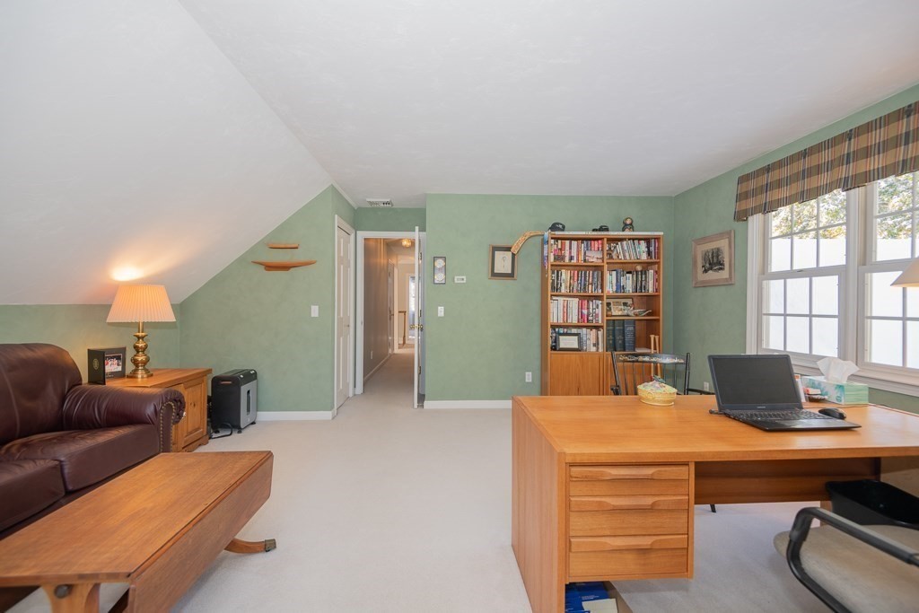 7 Round Table Road Shrewsbury, MA 01545 - Photo 28 of 39 a living room with furniture a bookshelf and a window