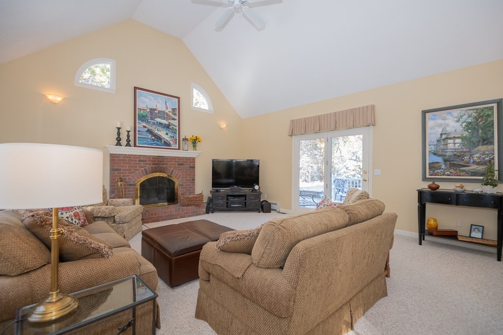 7 Round Table Road Shrewsbury, MA 01545 - Photo 10 of 39 a living room with furniture a large window and a fireplace