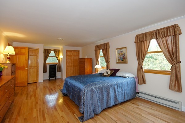 16 Depot Road Boxborough, MA 01719 - Photo 17 of 28 a bedroom with a bed and wooden floor