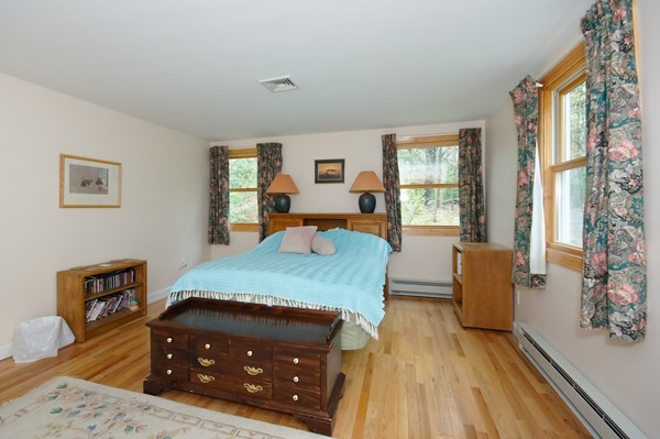 16 Depot Road Boxborough, MA 01719 - Photo 22 of 28 a bedroom with a bed and wooden floor