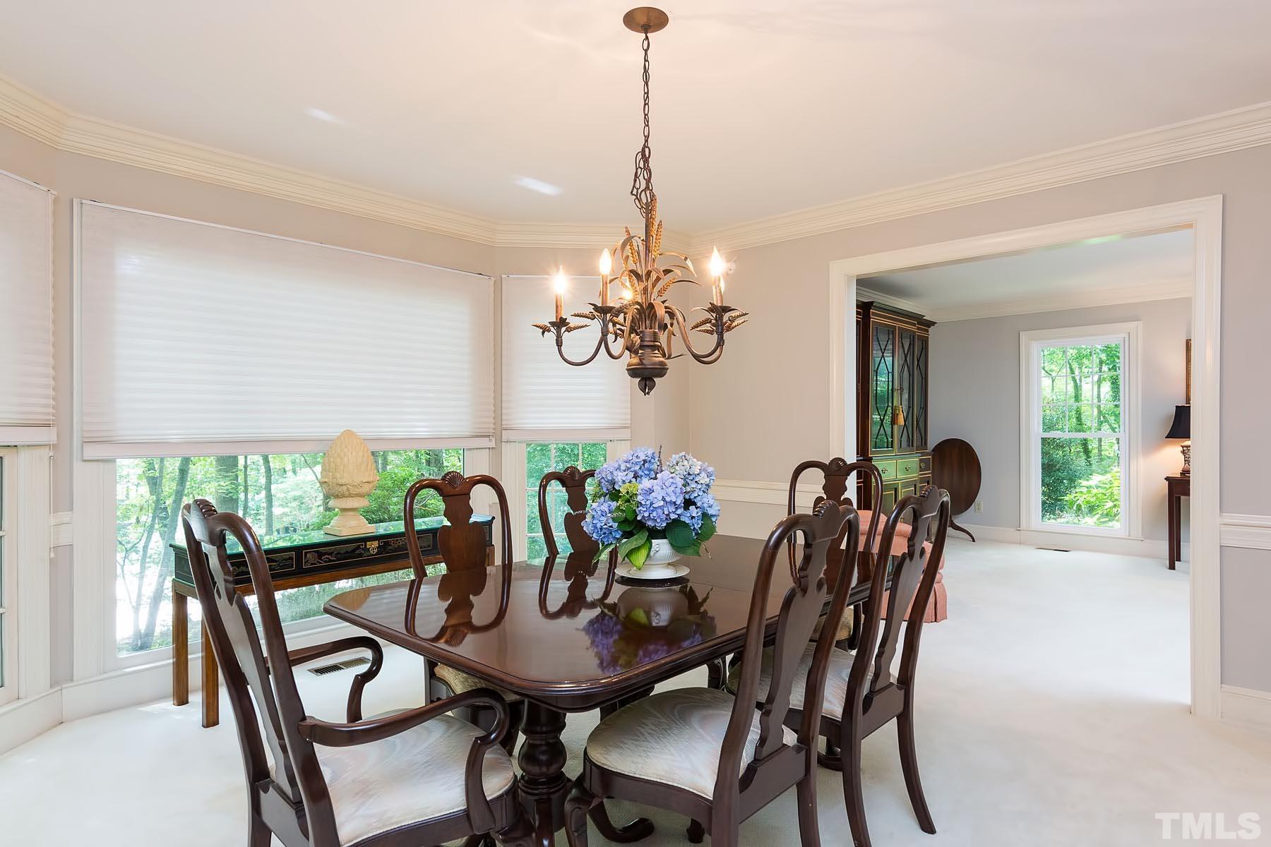 2301 Valley Forge Road Raleigh, NC 27615 - Photo 7 of 21 a view of a dining room with furniture a chandelier and wooden floor
