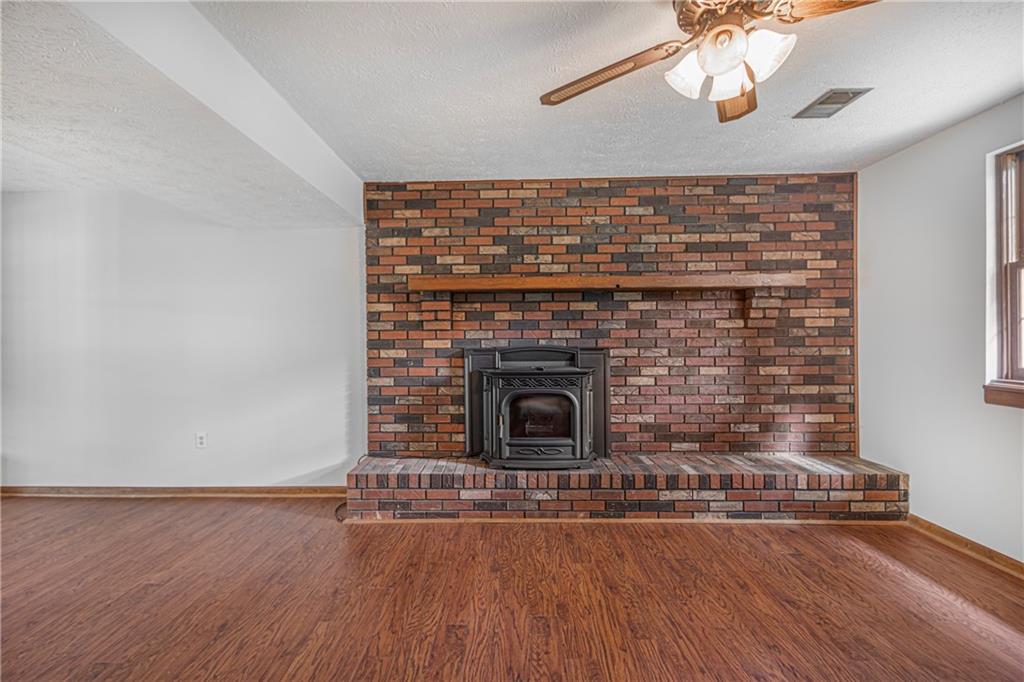 110 Lovi Road Baden, PA 15005 - Photo 19 of 33 a living room with a fireplace and wooden floor