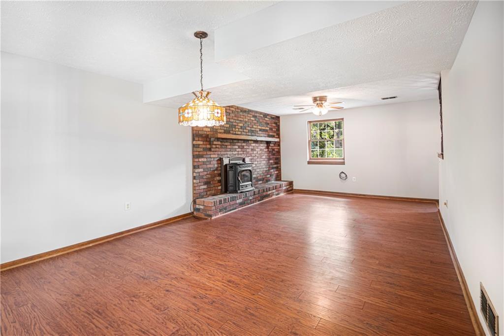 110 Lovi Road Baden, PA 15005 - Photo 20 of 33 a view of empty room with wooden floor and fireplace