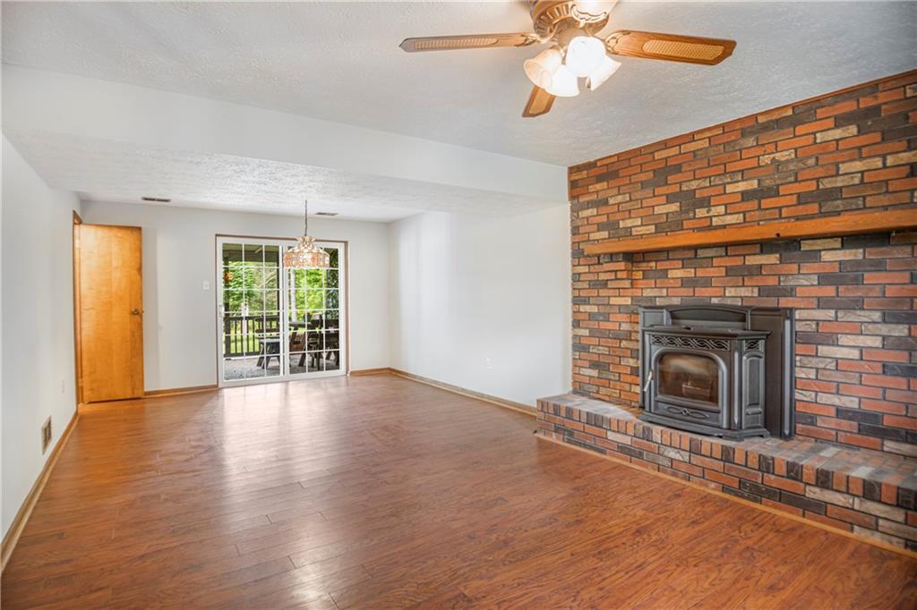 110 Lovi Road Baden, PA 15005 - Photo 21 of 33 an empty room with windows fireplace and fan