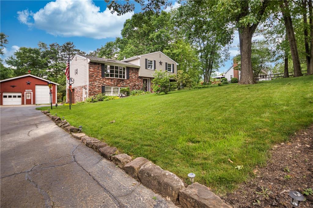 110 Lovi Road Baden, PA 15005 - Photo 26 of 33 a front view of a house with a garden and yard