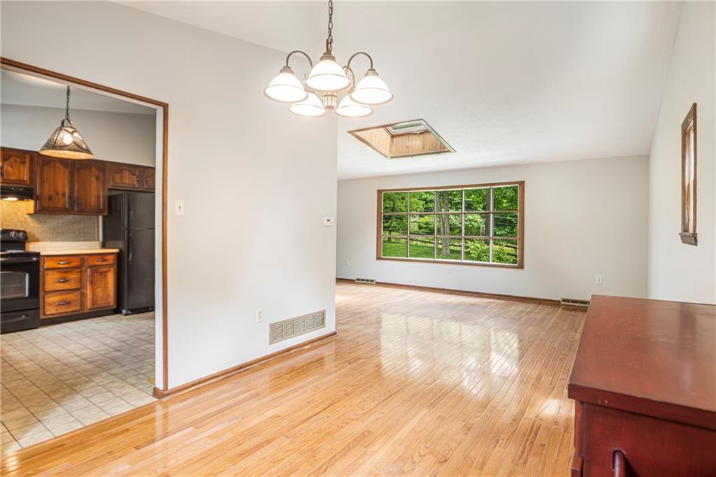 110 Lovi Road Baden, PA 15005 - Photo 7 of 33 a view of a room with wooden floor kitchen chandelier and a window