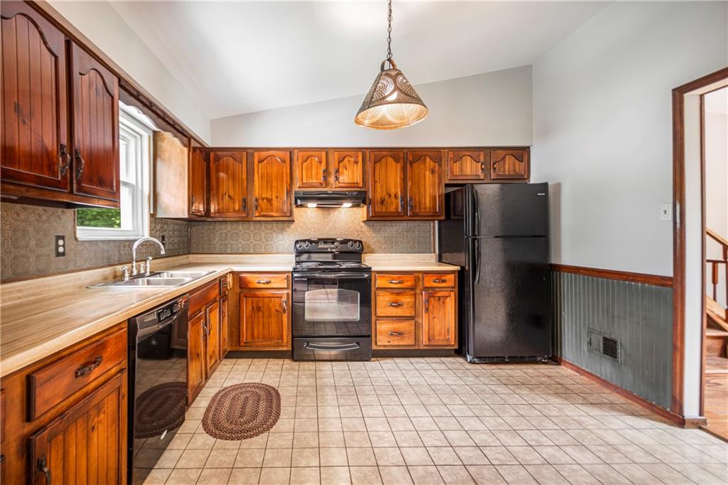 110 Lovi Road Baden, PA 15005 - Photo 8 of 33 a kitchen with stainless steel appliances granite countertop a sink a stove and a refrigerator