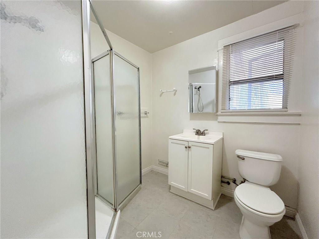 3449 4th Street, Unit 4 Riverside, CA 92501 - Photo 14 of 15 a white toilet sitting next to a bathroom sink