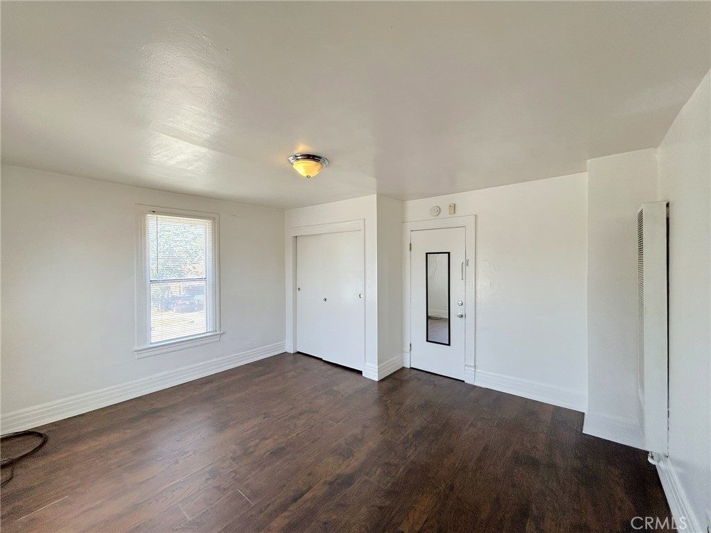 3449 4th Street, Unit 4 Riverside, CA 92501 - Photo 6 of 15 an empty room with windows and closet