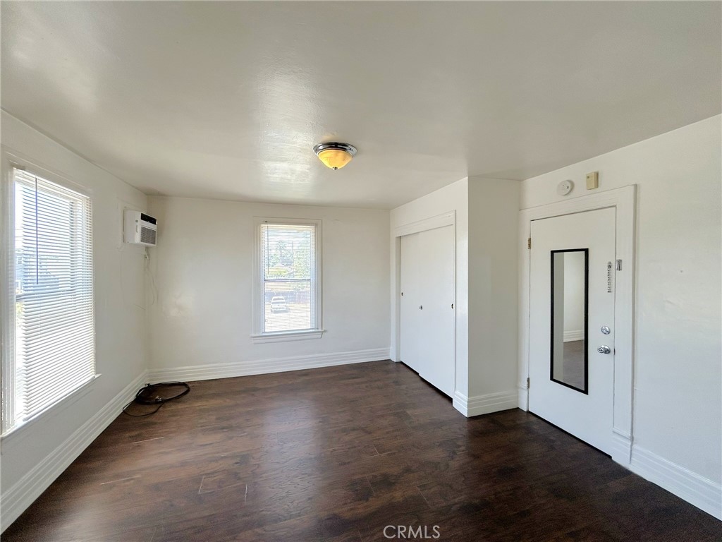 3449 4th Street, Unit 4 Riverside, CA 92501 - Photo 7 of 15 an empty room with wooden floor and windows