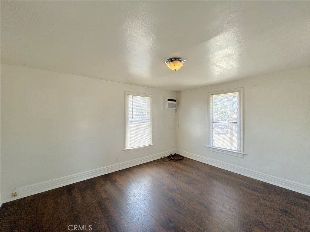 3449 4th Street, Unit 4 Riverside, CA 92501 - Photo 8 of 15 an empty room with wooden floor and windows