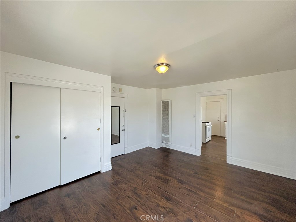 3449 4th Street, Unit 4 Riverside, CA 92501 - Photo 9 of 15 an empty room with wooden floor and windows