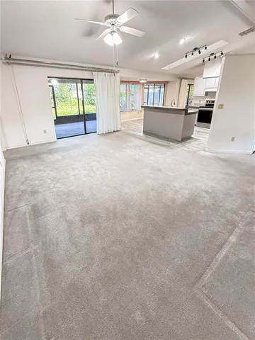 a kitchen with stainless steel appliances kitchen island granite countertop a sink and a stove