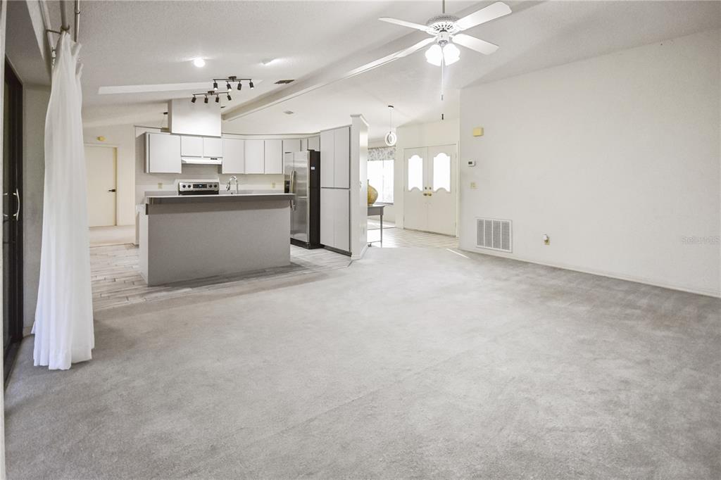 8143 Wooden Drive Spring Hill, FL 34606 - Photo 12 of 36 a view of a kitchen with refrigerator and windows