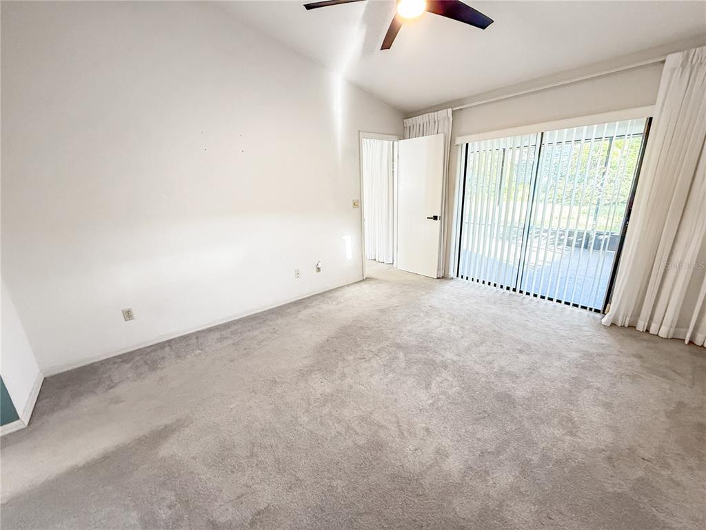 8143 Wooden Drive Spring Hill, FL 34606 - Photo 20 of 36 an empty room with fan and windows