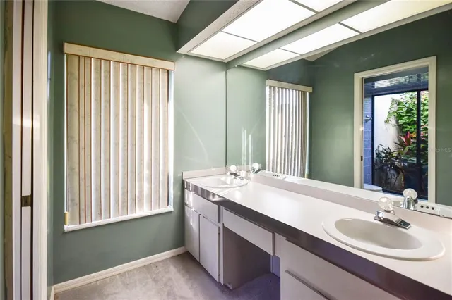 an empty room with a ceiling fan and windows