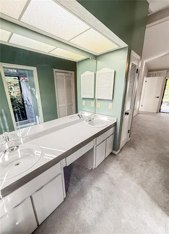 an empty room with a ceiling fan and a window