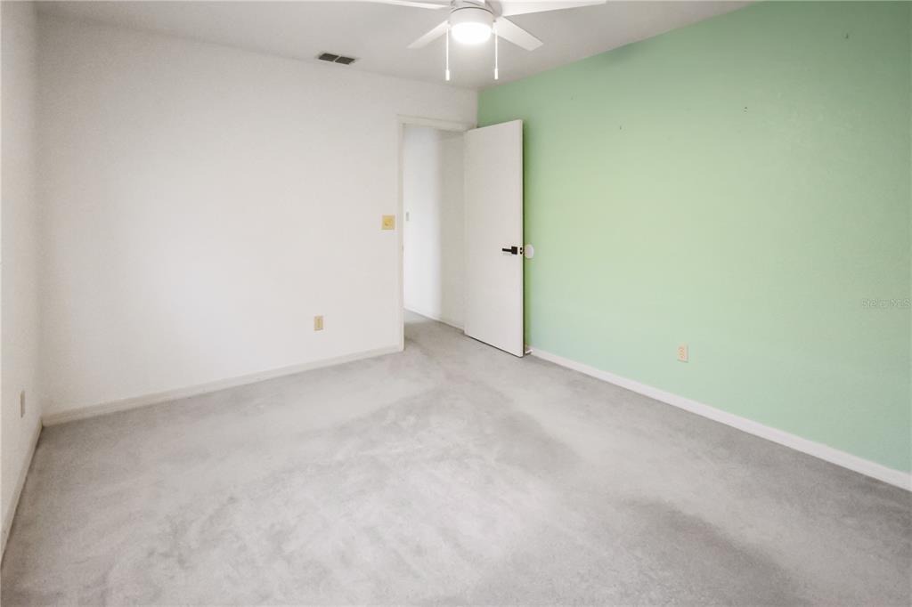 8143 Wooden Drive Spring Hill, FL 34606 - Photo 27 of 36 an empty room with a chandelier fan and closet