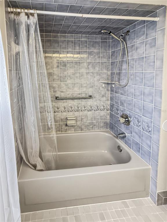 8143 Wooden Drive Spring Hill, FL 34606 - Photo 31 of 36 a bathroom with a shower and a bathtub